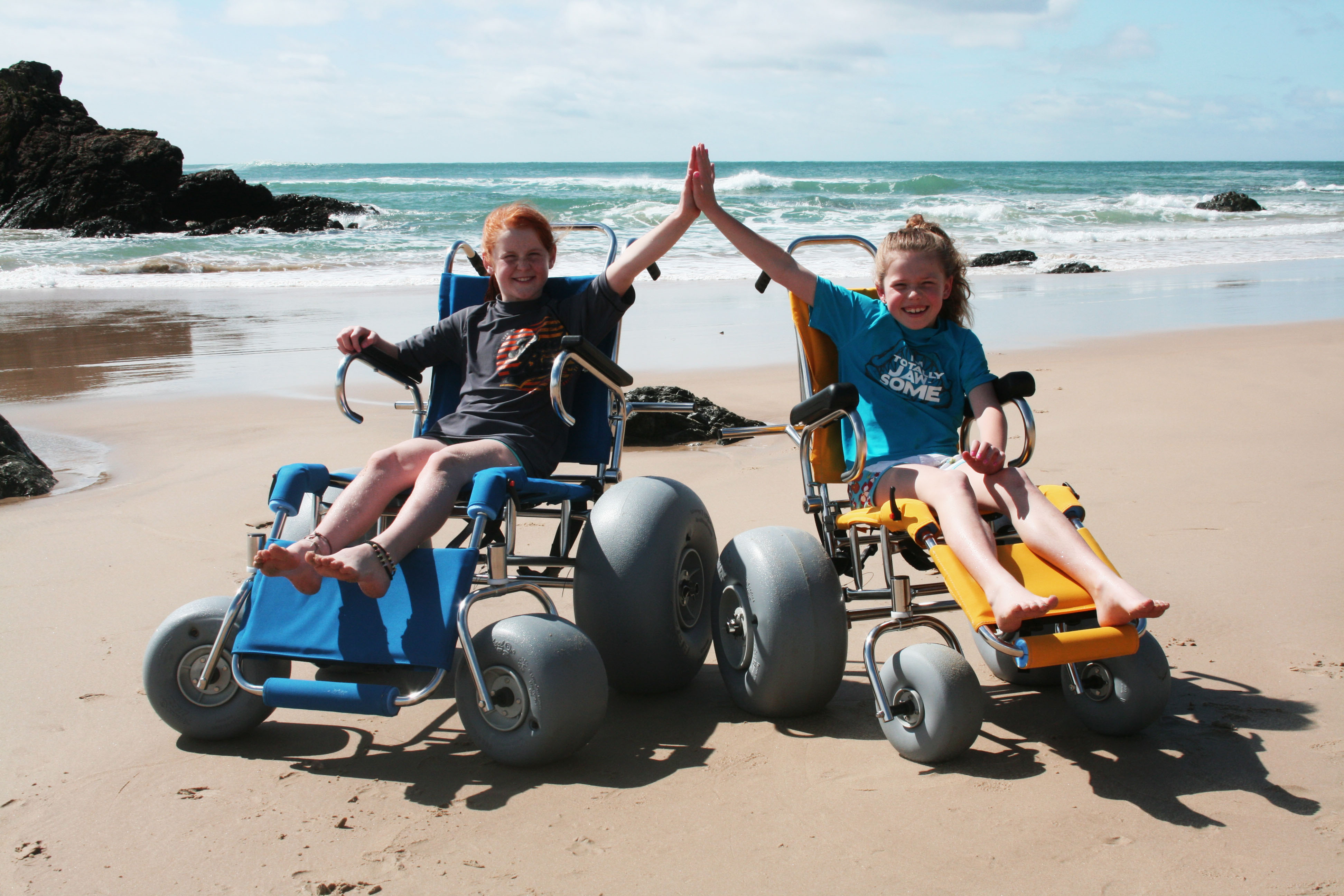 children in beach wheelchairs children in beach wheelchairs